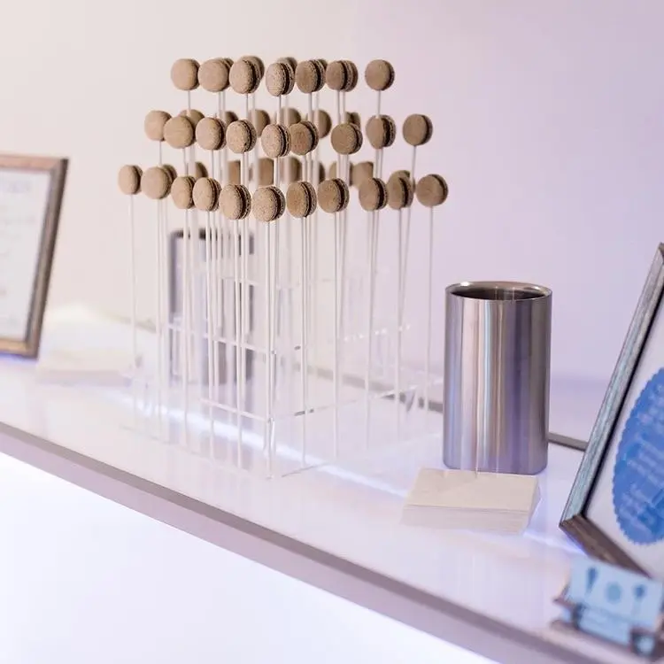 Woman in formal attire smiling while holding smoking mocktail drinks