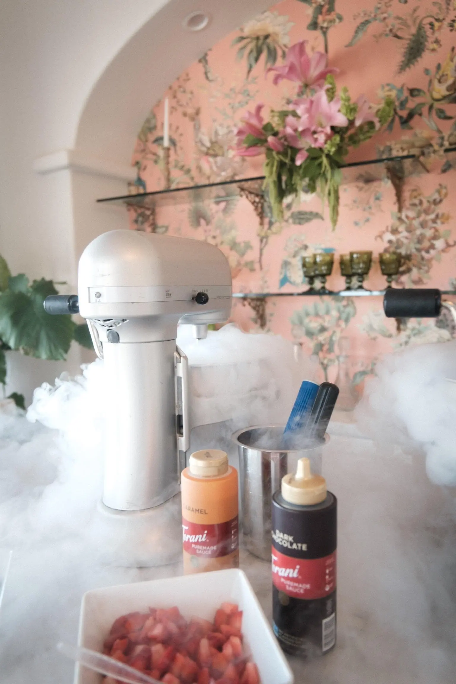 Woman in formal attire smiling while holding smoking mocktail drinks