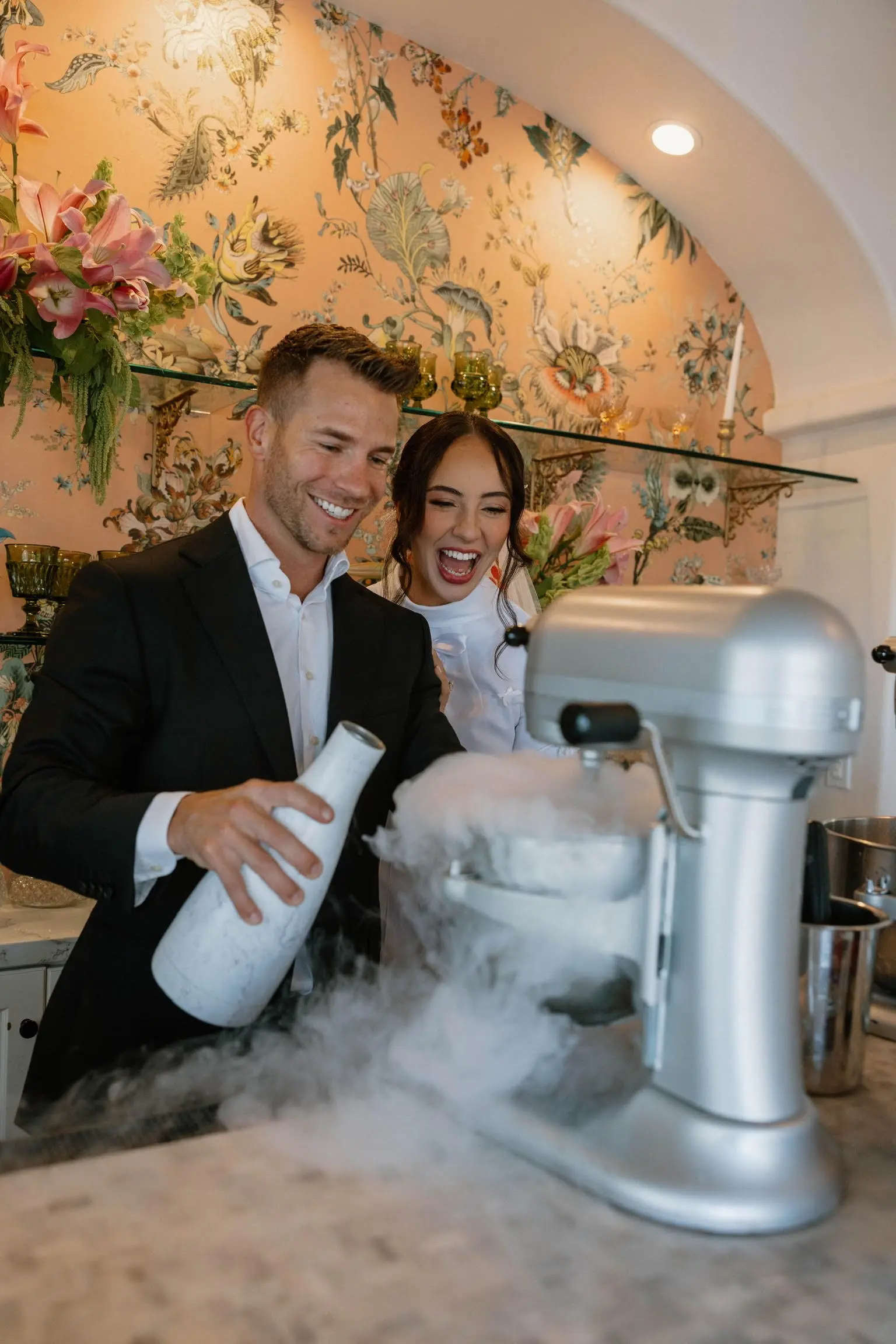Woman in formal attire smiling while holding smoking mocktail drinks