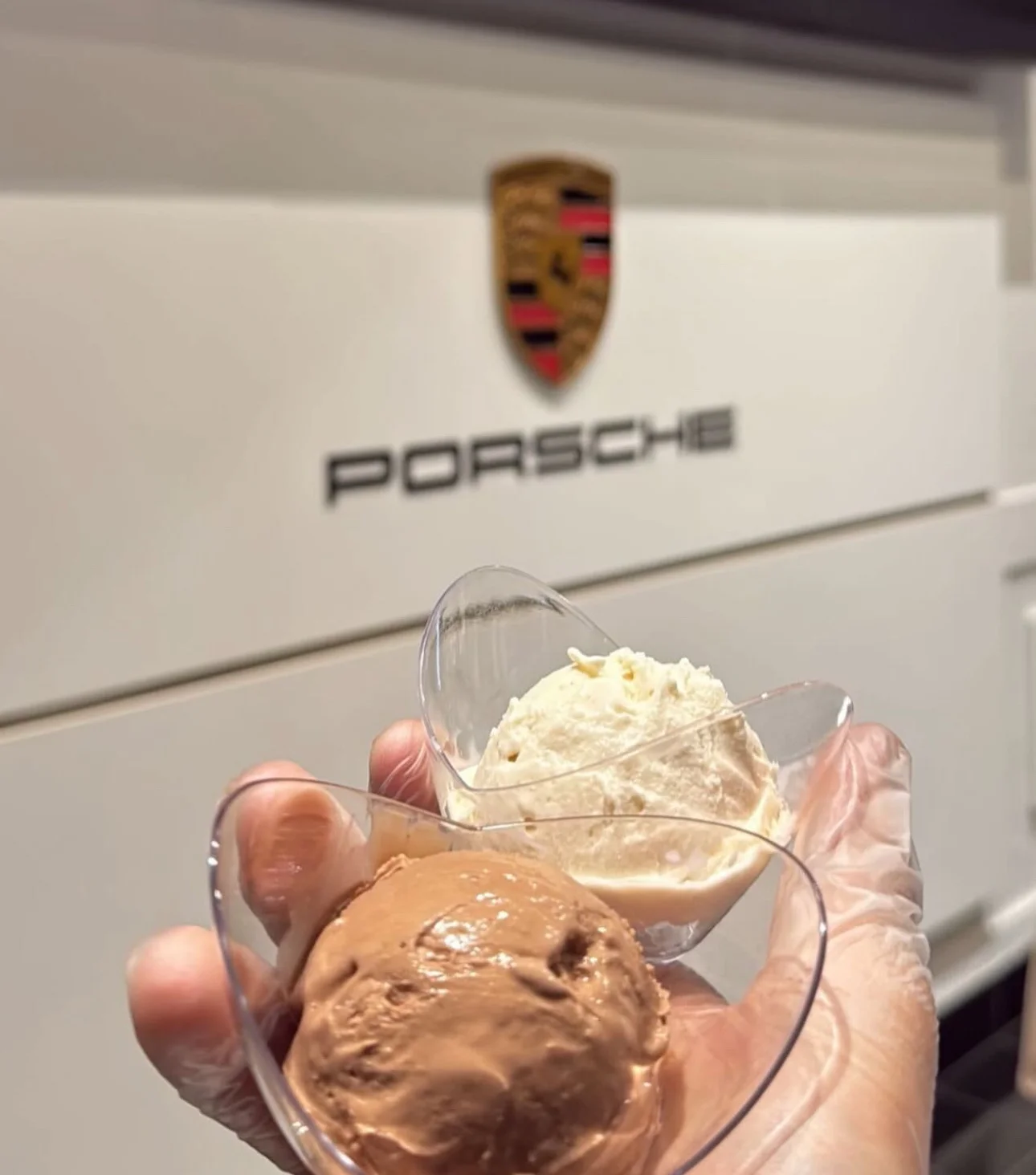 Corporate brand activation ice cream catering: two scoops of nitrogen ice cream served in front of a car brand's logo wall